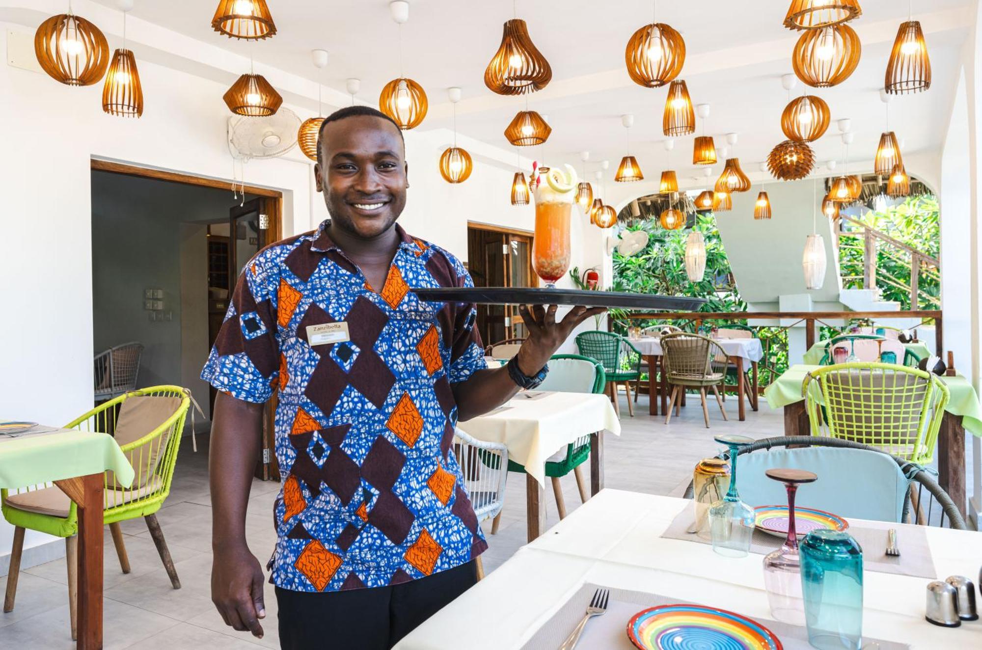 Zanzibella Hotel & Spa Kiwengwa  Bagian luar foto A waiter at a restaurant in Ghana